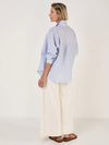 Woman wearing Mondo Corsini blue and white Pinstripe blouse on a white background. Rear View