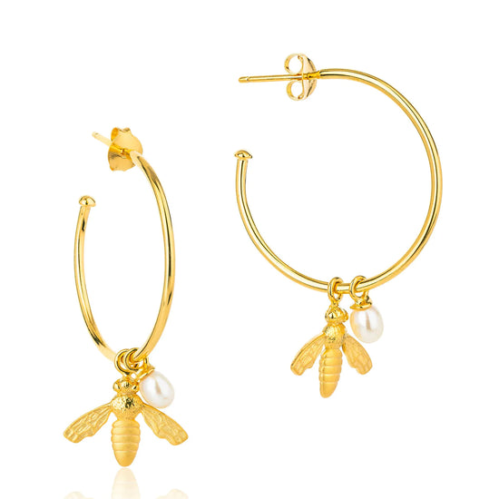 Large gold hoop earrings with flying bee pendants and a rice pearl drop with butterfly earring fastenings