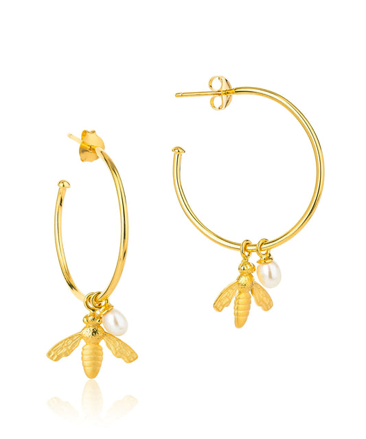 Large gold hoop earrings with flying bee pendants and a rice pearl drop with butterfly earring fastenings