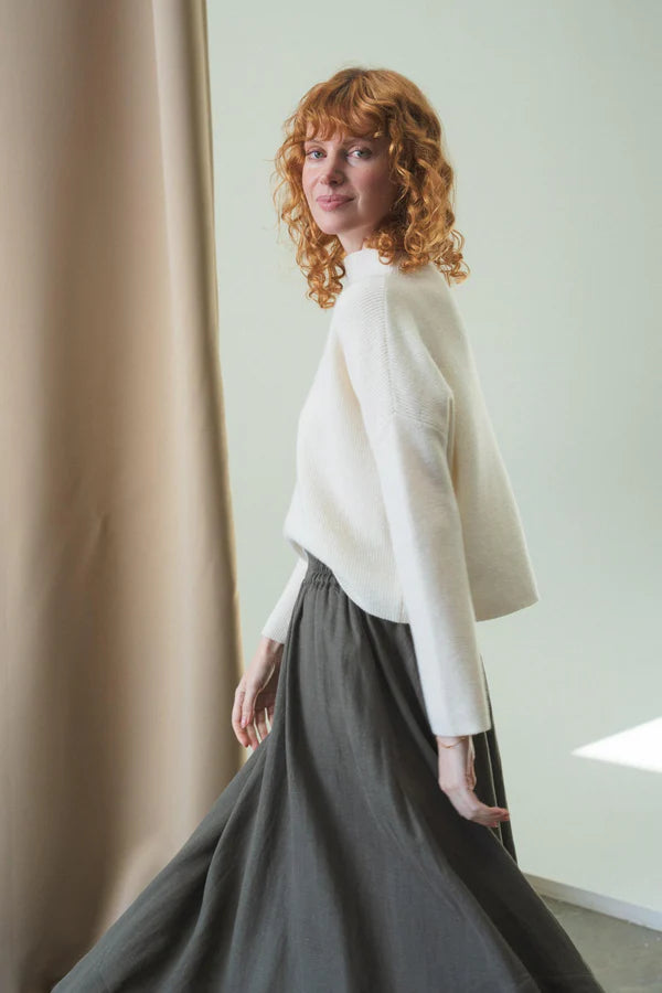 white ribbed jumper with stand neck and long sleeves side view 