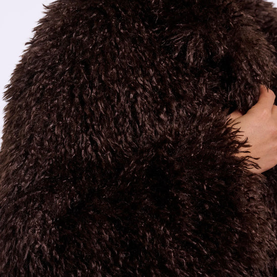 Close-up of a brown fluffy garment with a blurred background