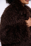 Close-up of a brown fluffy garment with a blurred background