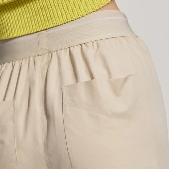 Close up of oyster grey trousers rear pocket and waistband