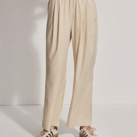 Model wearing loose fitting oyster grey trousers, front view