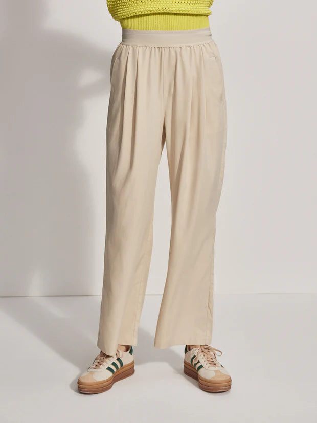 Model wearing loose fitting oyster grey trousers, front view