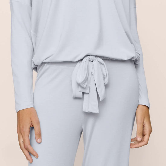 Light blue long-sleeve top and pants set on a beige background
