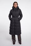 A model wearing a long black puffer coat with a hood and a matching belt, paired with dark brown leather pants, against a plain light gray studio background.