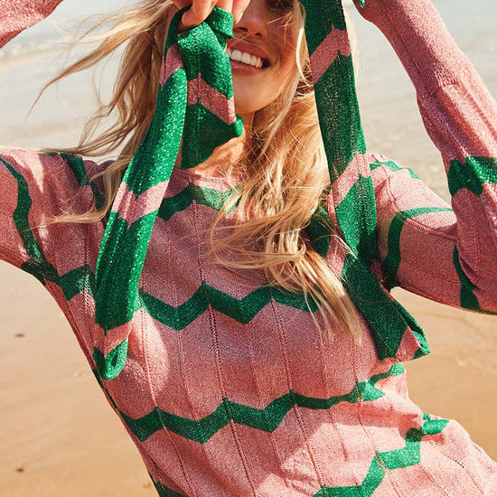 Pink crew neck long sleeved top with green chevron in sparkle material with slim scarf