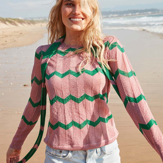 Pink crew neck long sleeved top with green chevron in sparkle material with slim scarf