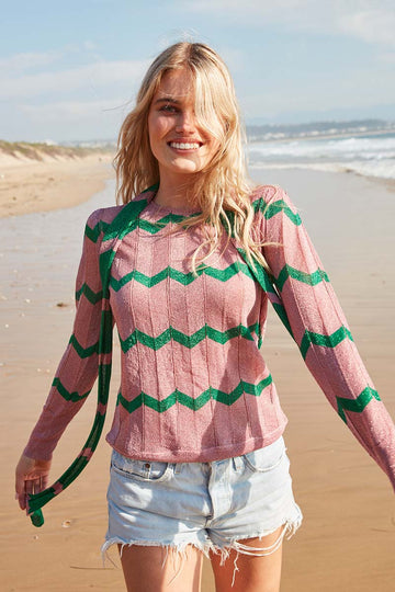 Pink crew neck long sleeved top with green chevron in sparkle material with slim scarf