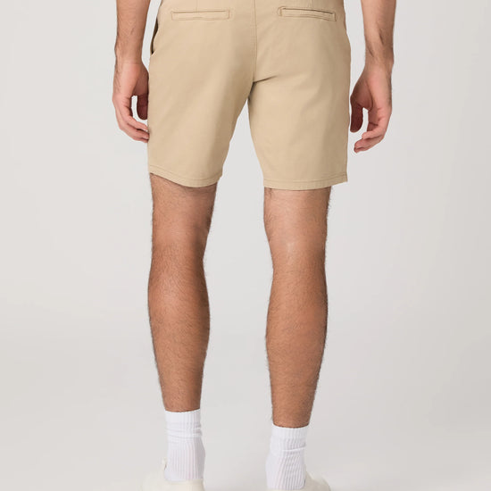 Beige shorts worn by a person on a white background from paige