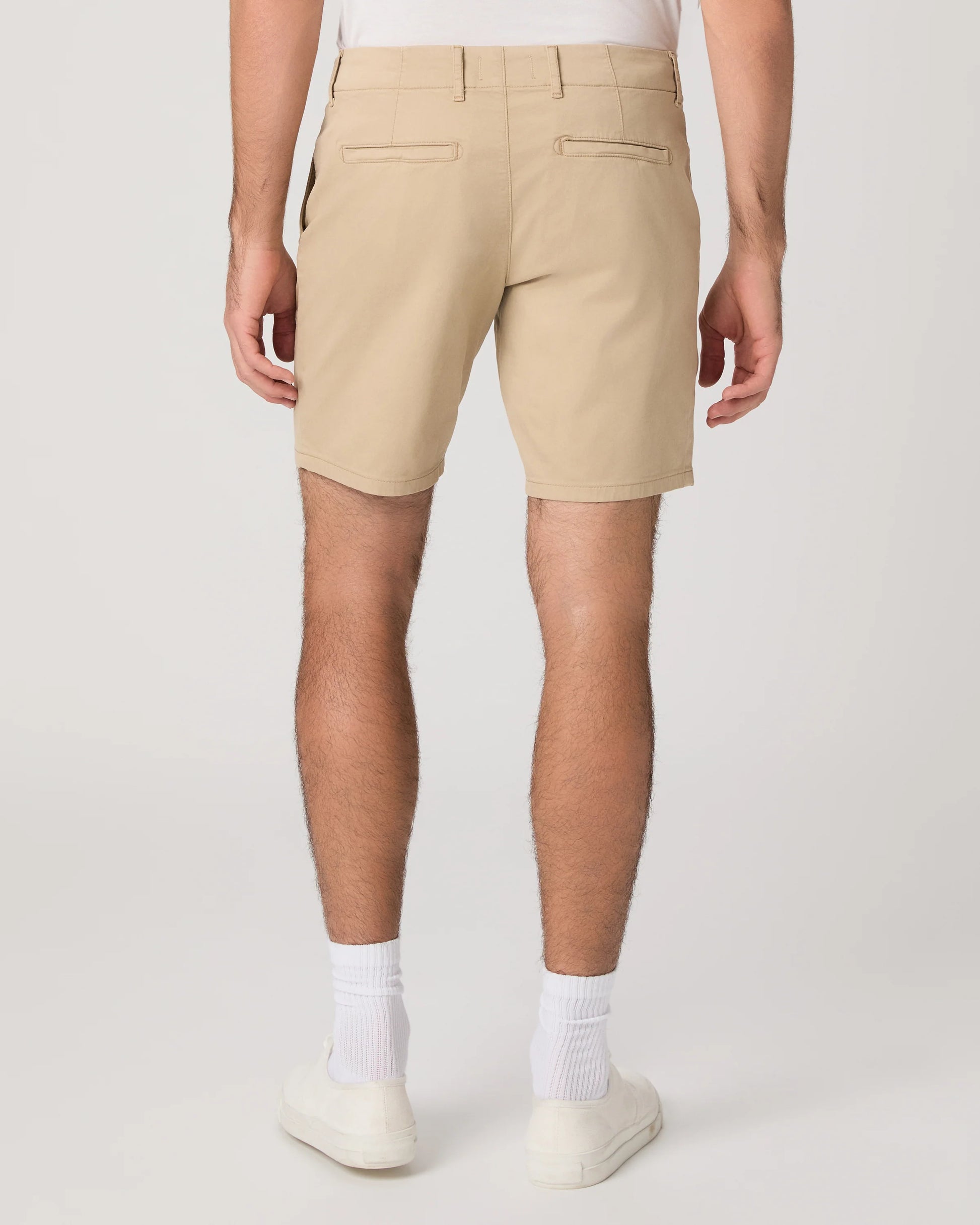 Beige shorts worn by a person on a white background from paige
