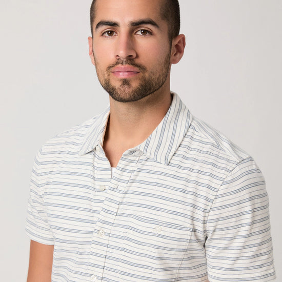 Man wearing a striped shirt against a plain background