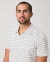 Man wearing a striped shirt against a plain background
