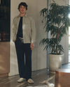 Man wearing Navy blue pants with a white drawstring by Paige with stripe jacket