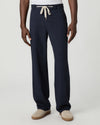 Navy blue pants with a white drawstring by Paige worn by a man on a light gray background