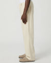 Beige paige pants worn by a man on a white background side view