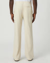 Beige paige pants worn by a man on a white background rear view