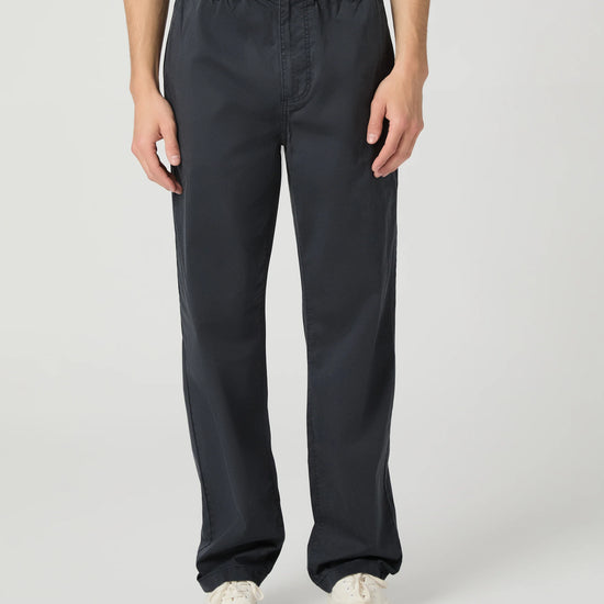Person wearing black pants on a white background