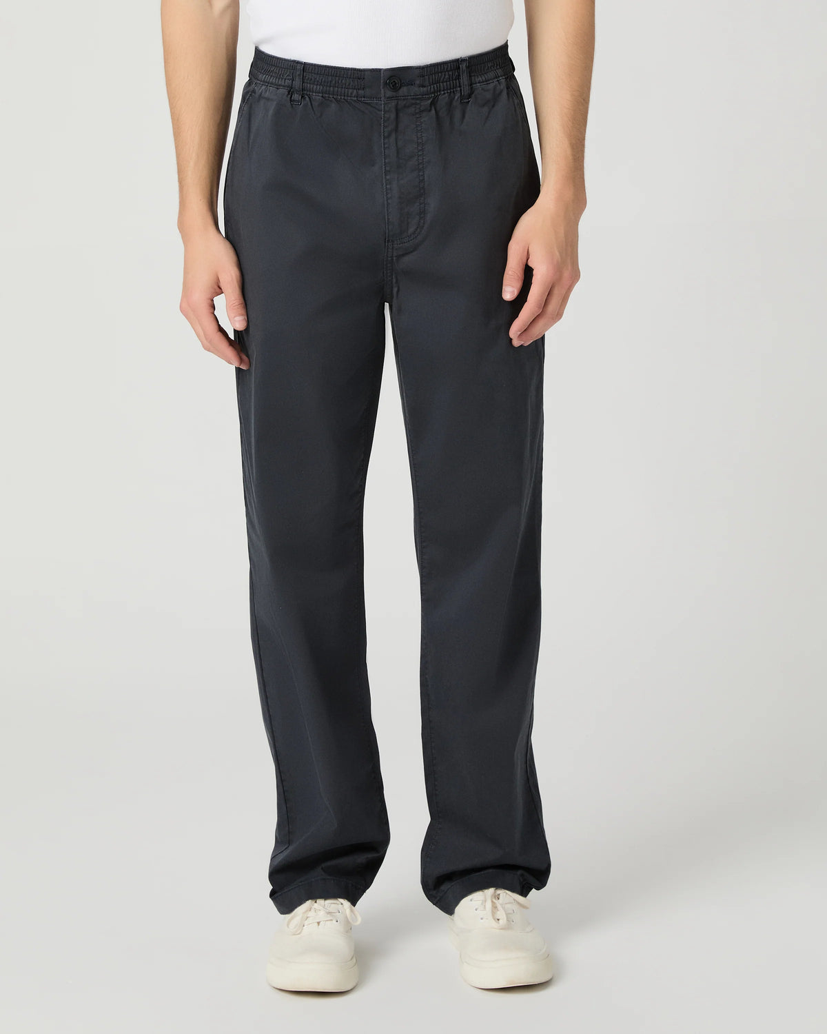 Person wearing black pants on a white background