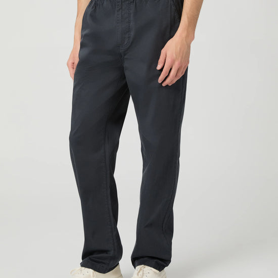Man wearing navy trousers on white background