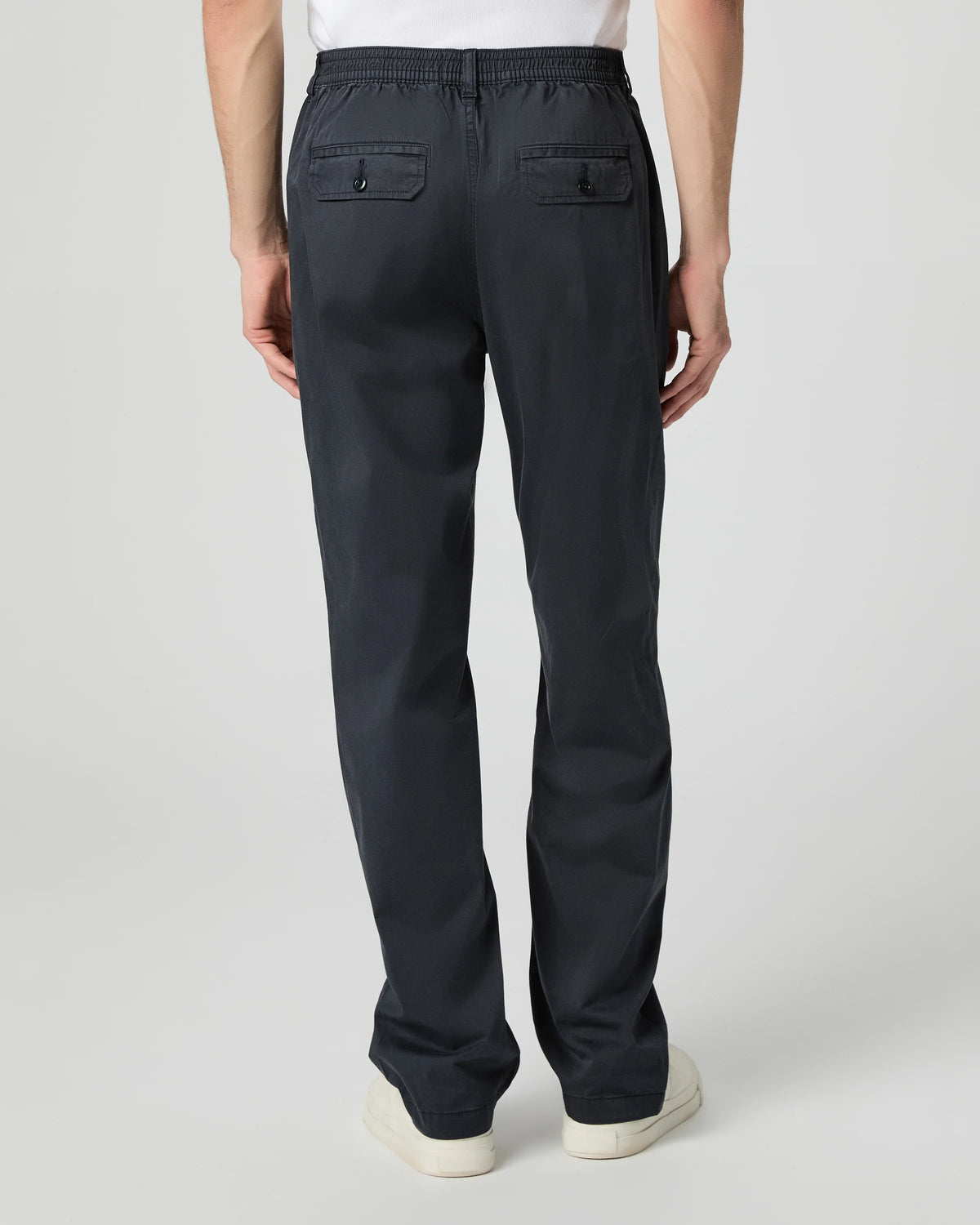 Person wearing black pants on a white background