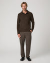 A man modeling a dark brown long-sleeve polo shirt and matching brown trousers against a light gray studio background.