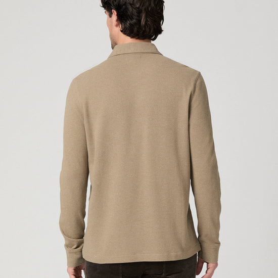 Man wearing beige polo rear view