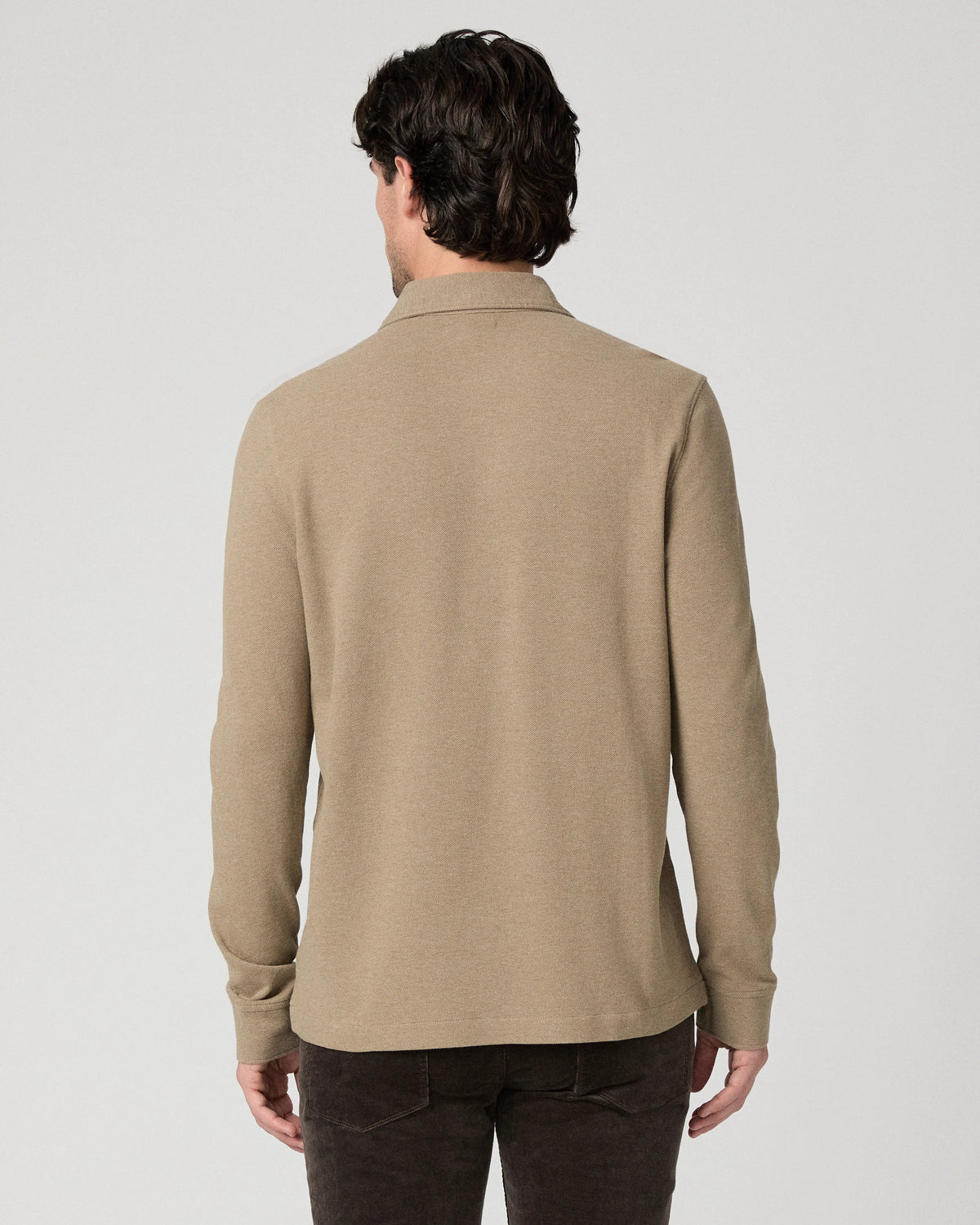 Man wearing beige polo rear view