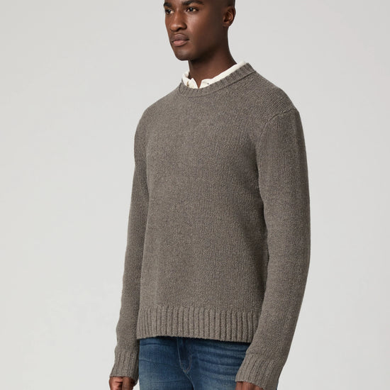 man wearing grey jumper side view