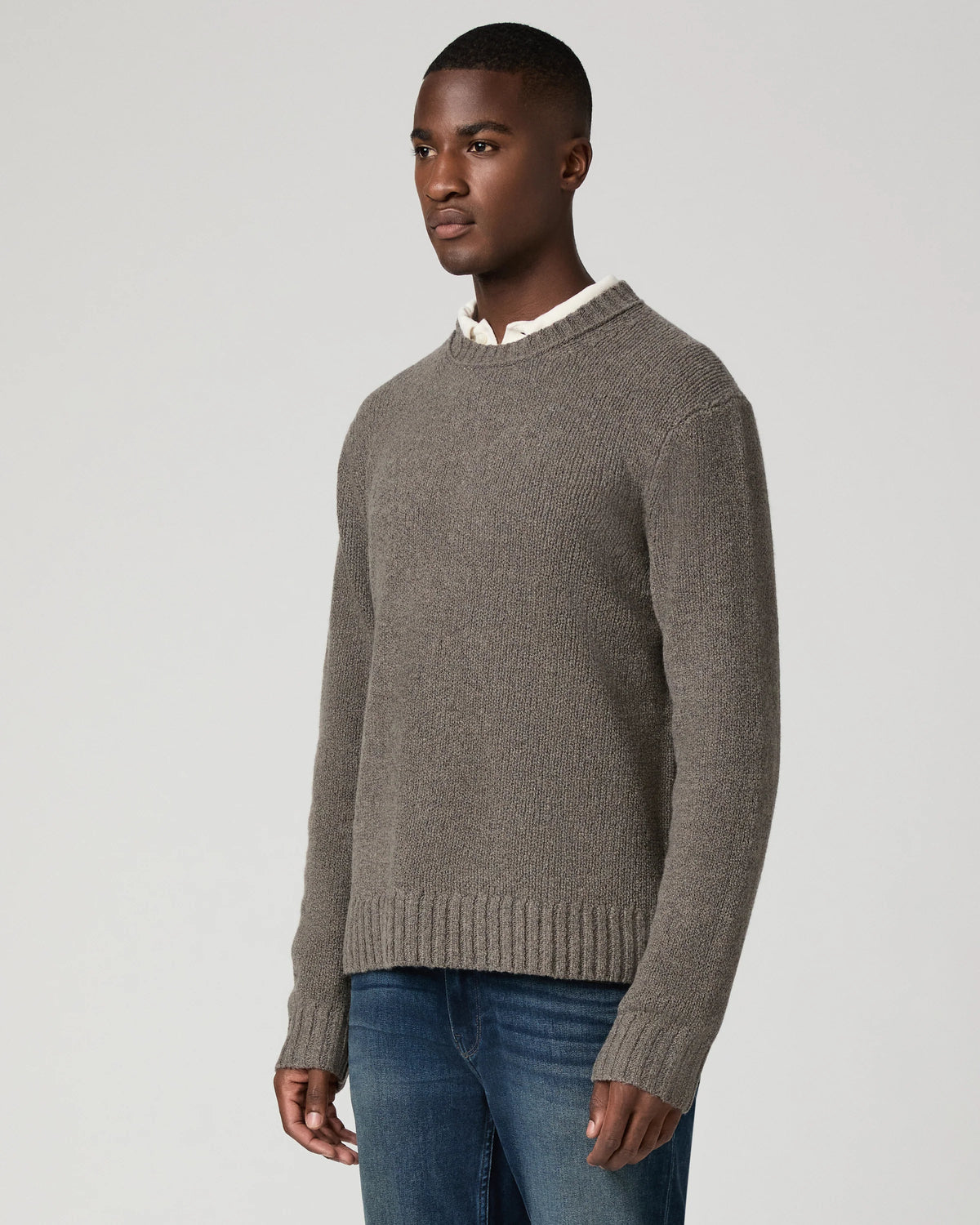 man wearing grey jumper side view