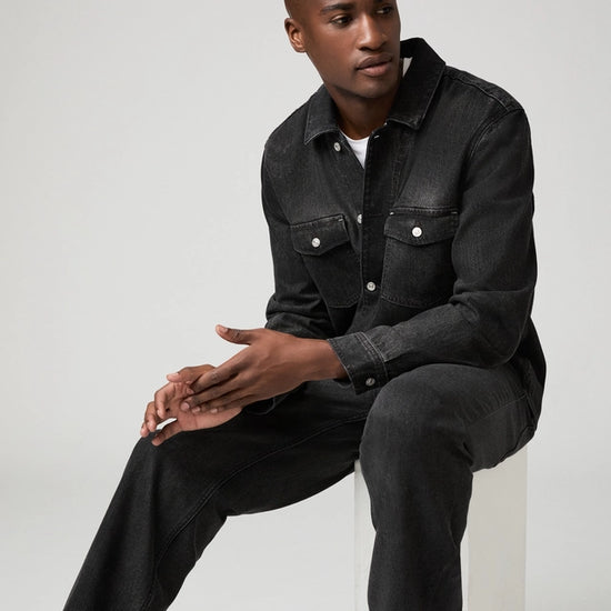 Man wearing black jeans and denim shirt