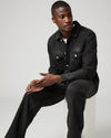 Man wearing black jeans and denim shirt