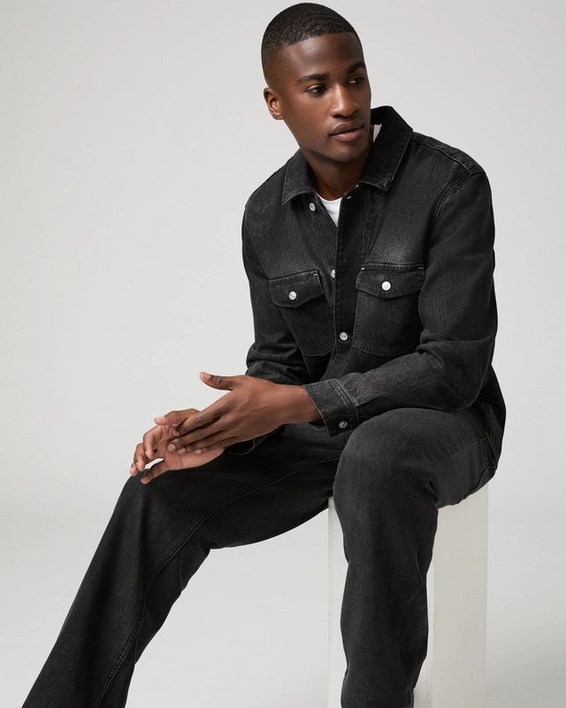 Man wearing black jeans and denim shirt
