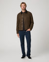 Man wearing green jacket and blue jeans 