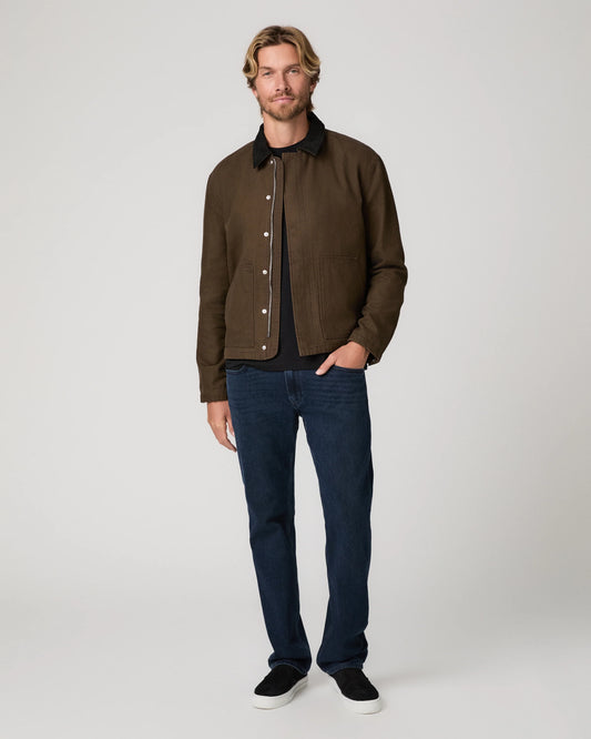 Man wearing green jacket and blue jeans 