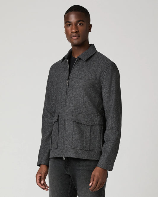 Man wearing grey zip jacket and black jeans  side view