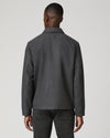Man wearing grey zip jacket and black jeans  rear view