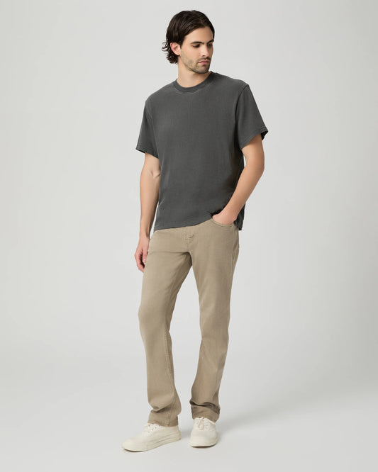 Man wearing a gray t-shirt and beige pants on a white background from Paige
