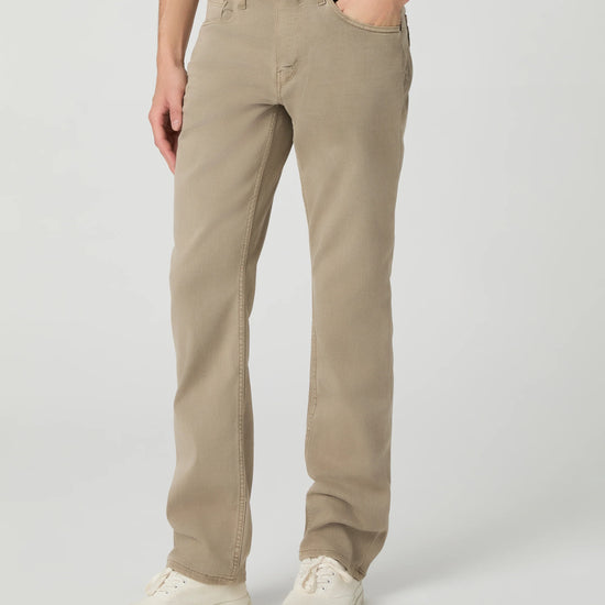Person wearing beige pants on a plain background from paige