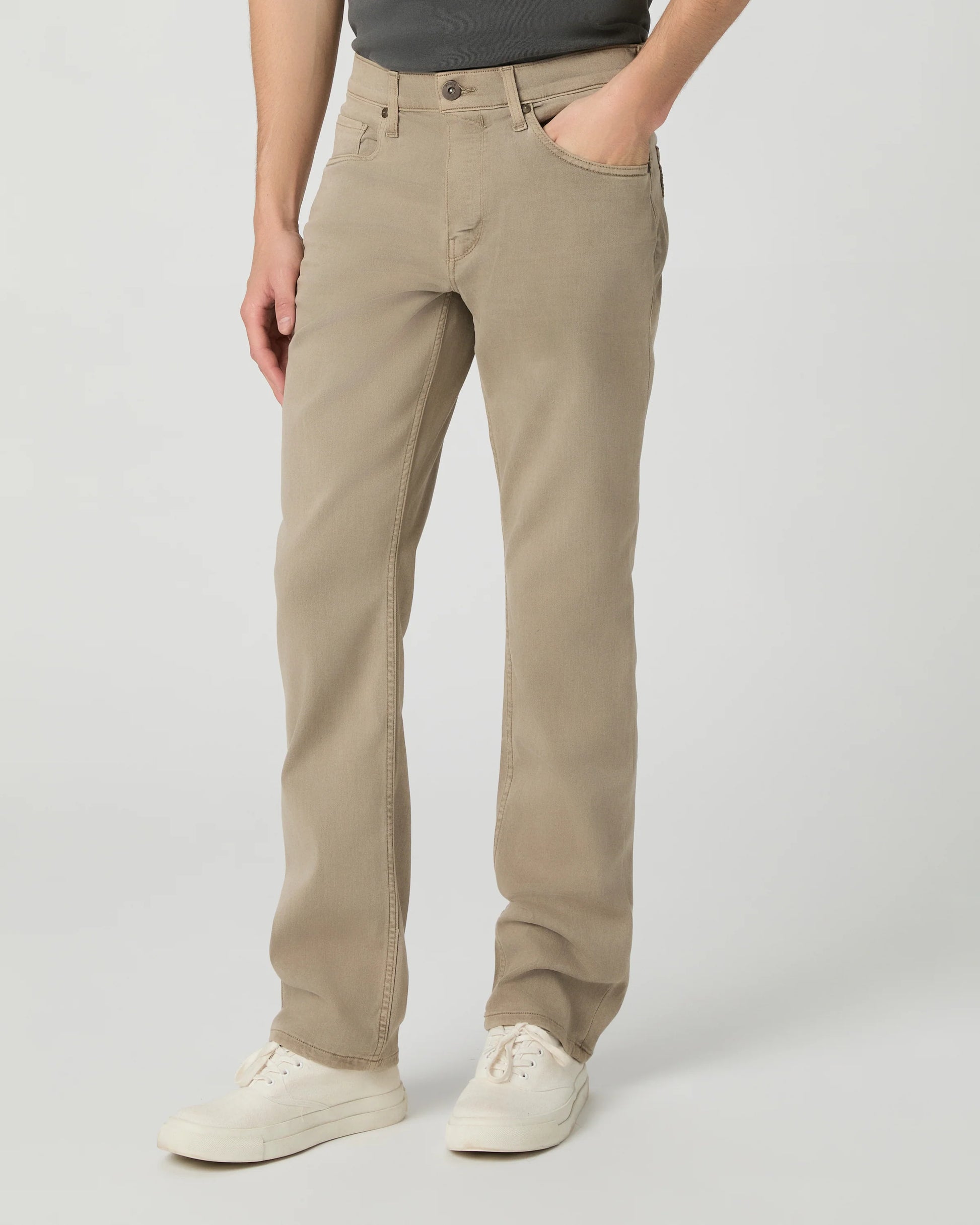 Person wearing beige pants on a plain background from paige