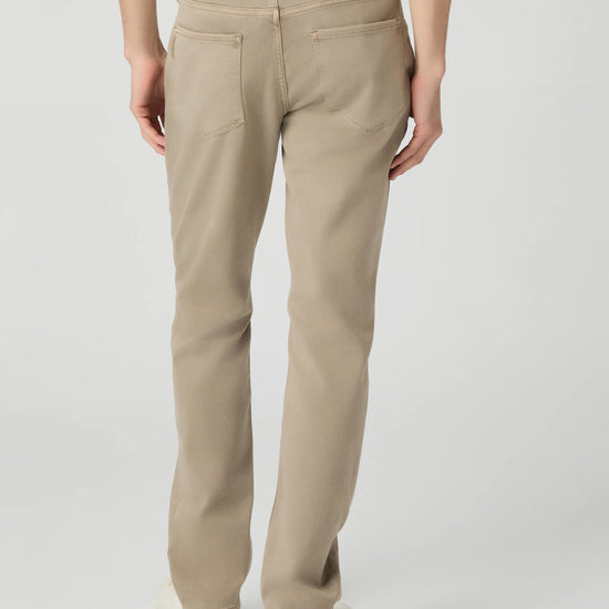 Beige pants worn by a person on a light gray background from paige