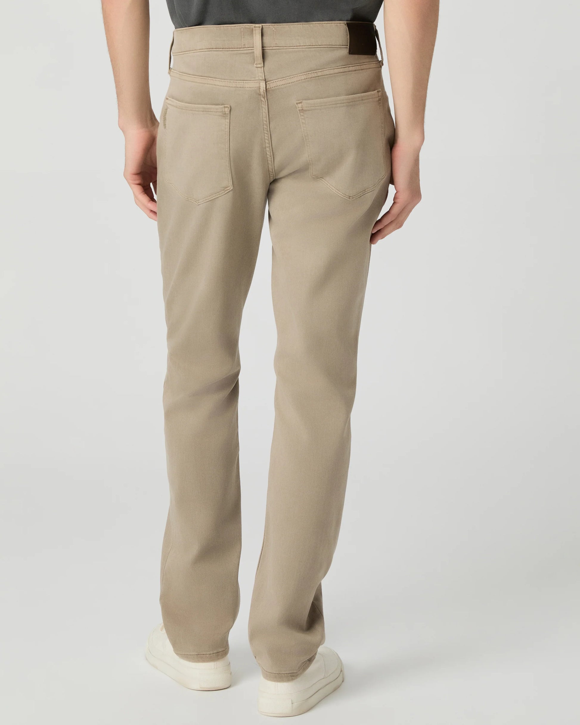 Beige pants worn by a person on a light gray background from paige