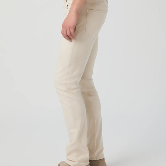 Beige pants worn by a person on a white background from Paige