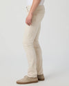Beige pants worn by a person on a white background from Paige