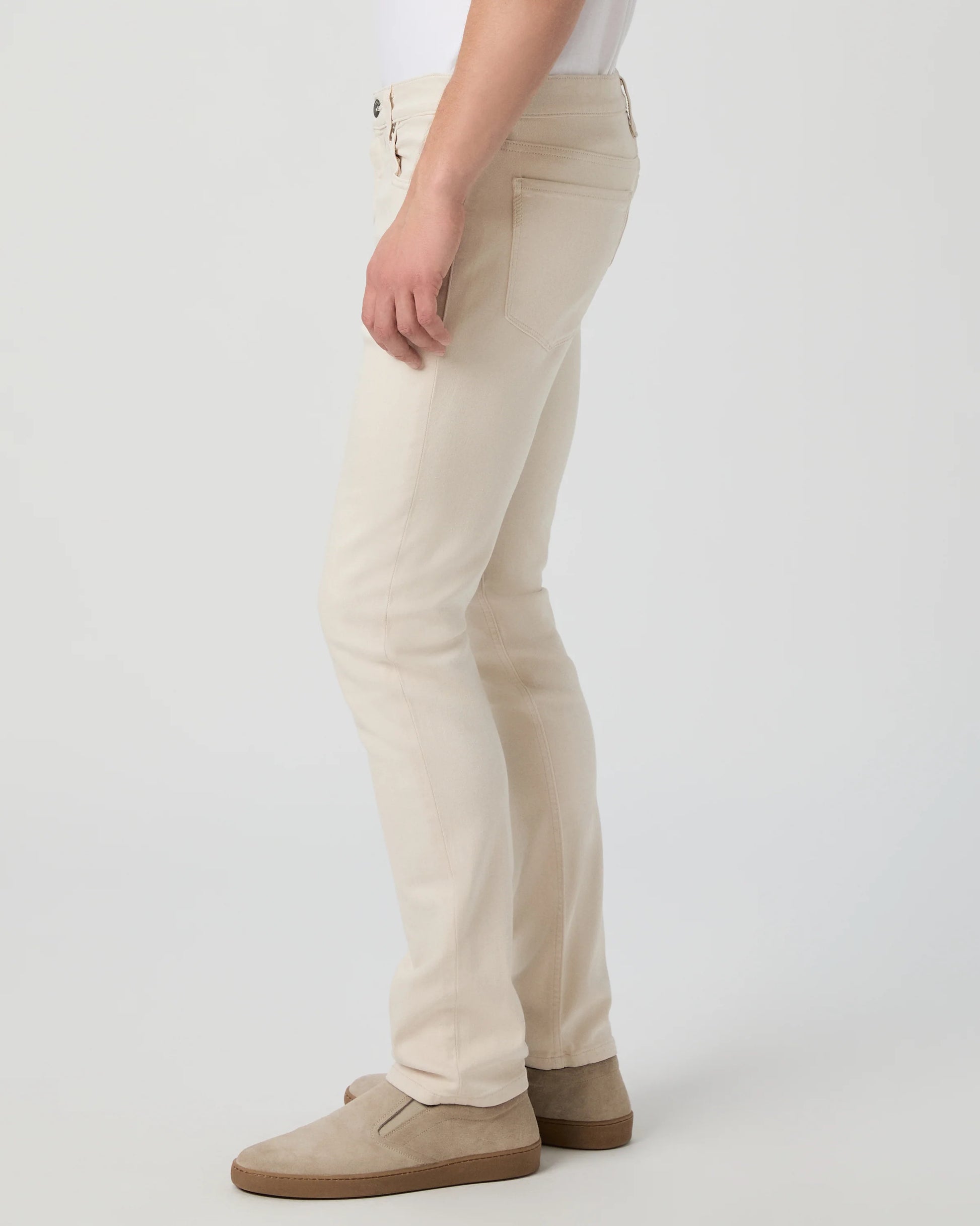 Beige pants worn by a person on a white background from Paige
