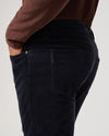 navy blue micro corduroy slim straight leg jeans with metallic hardware from paige close up of rear