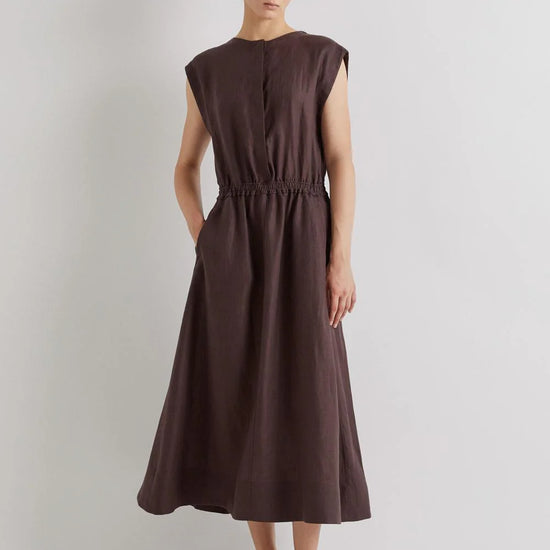 Woman wearing a brown linen dress against a plain background from Mei MeiJ