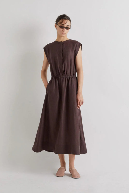 Woman wearing a brown linen dress against a plain background from Mei MeiJ