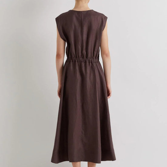 Woman wearing a brown dress on a light gray background from Mei MeiJ